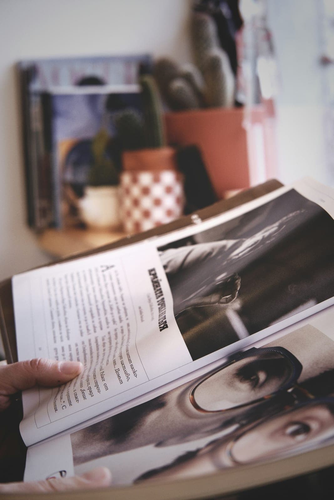 A person reading a magazine of black and white photographs