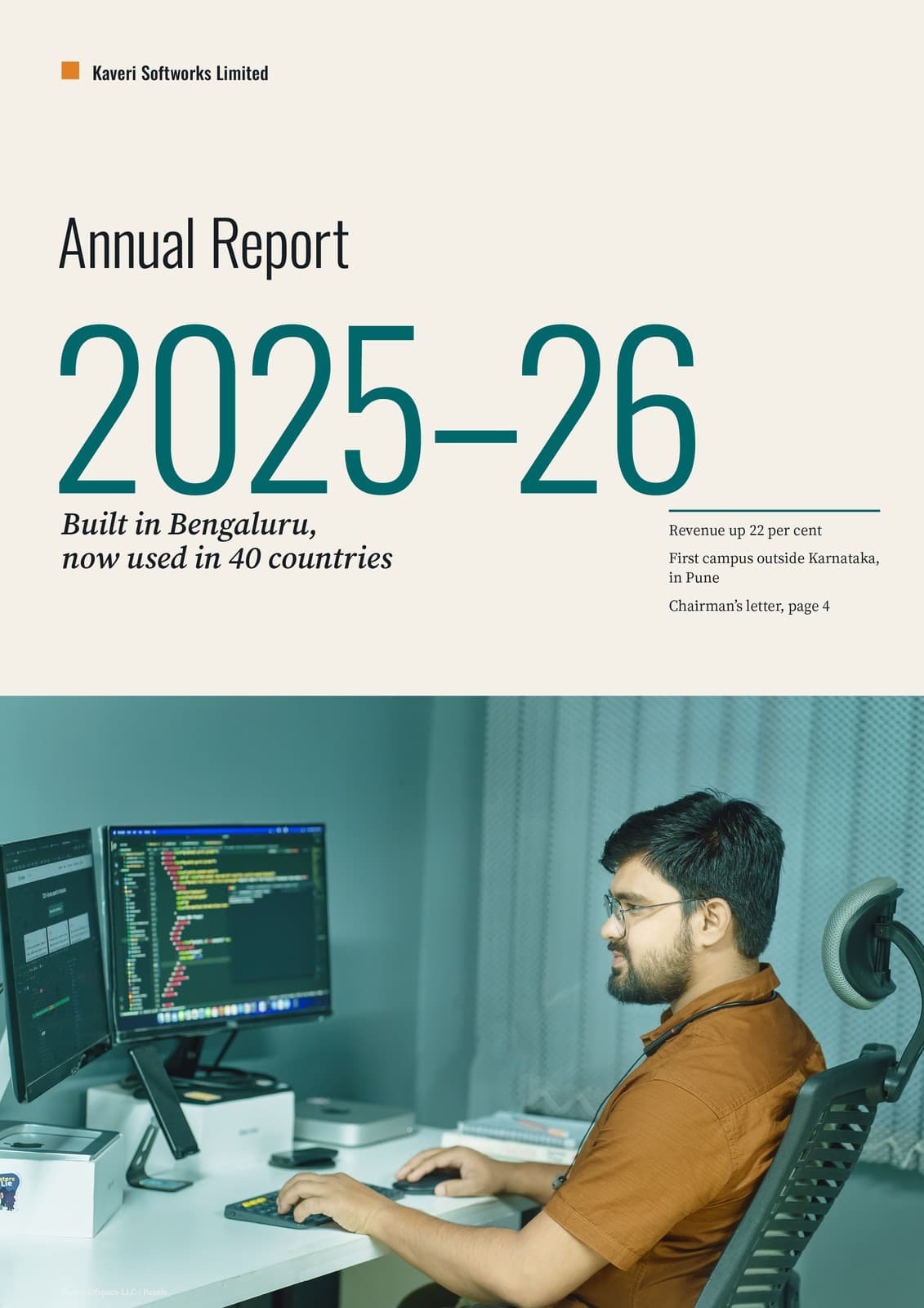 Cover of the Kaveri Softworks Annual Report 2025–26: the year set large on paper above a photograph of a software engineer at his desk, designed by DigiMagz