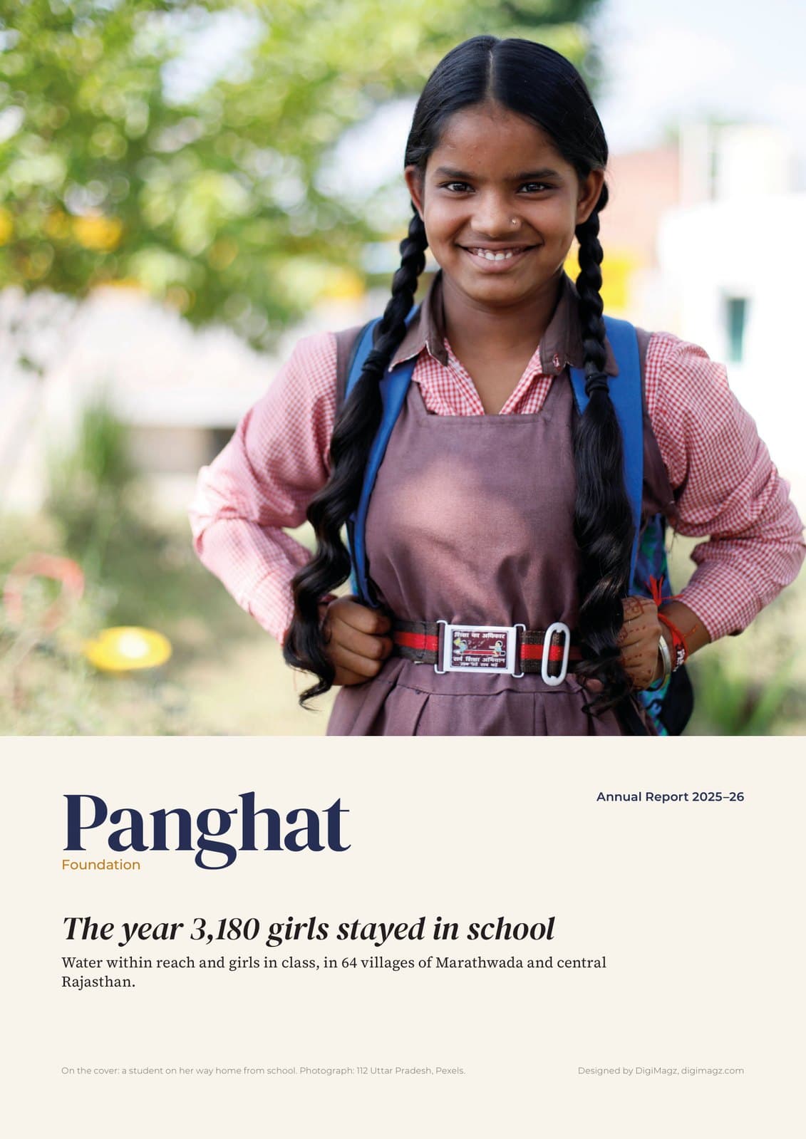 Cover of Panghat Foundation Annual Report 2025–26: a smiling girl in a school uniform with a school bag, cover line The year 3,180 girls stayed in school, designed by DigiMagz