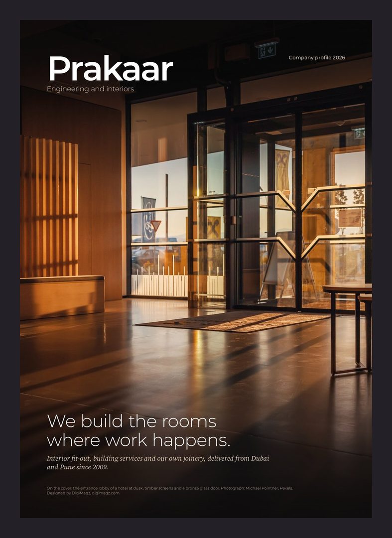 Prakaar company profile cover: a lit office interior at dusk with the line We build the rooms where work happens